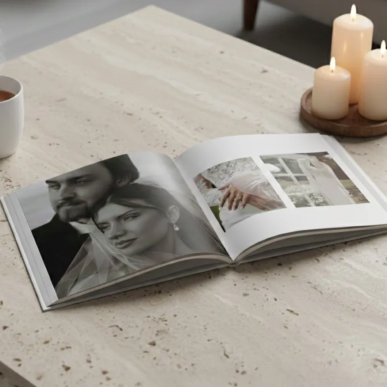 Open klikkie wedding photo book on a lay-flat spread showing the ceremony